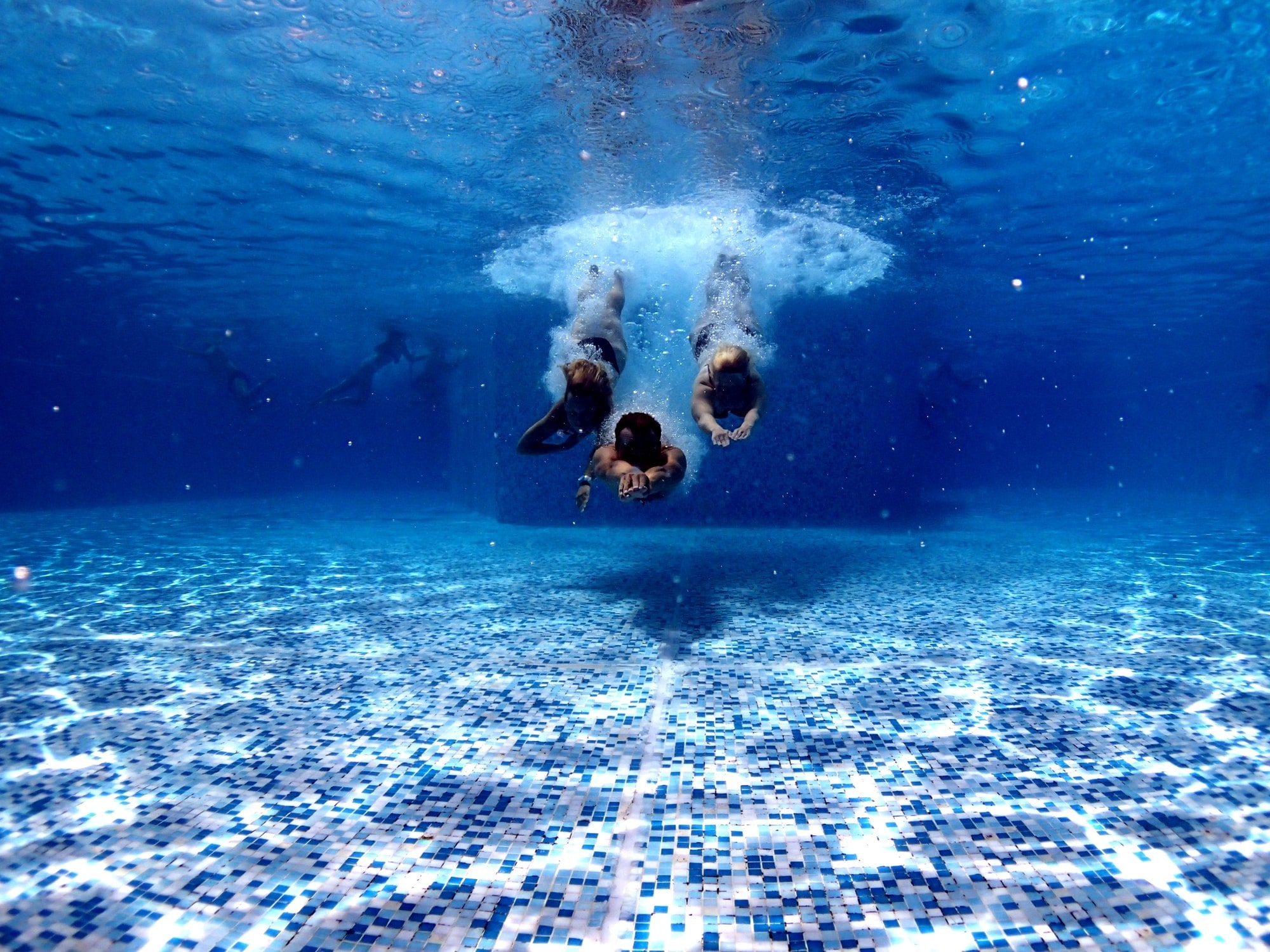 people plunging in a swimming pool